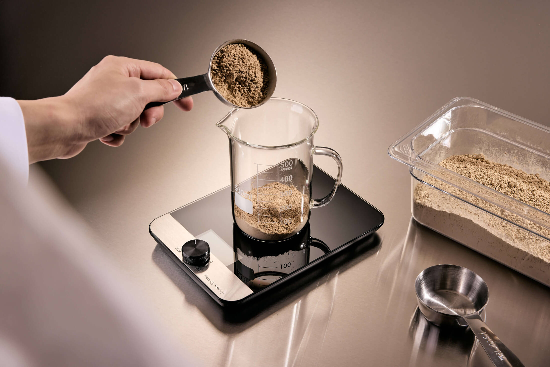 Maia Farms mycelium flour being measured in a food science lab using a digital scale for precision formulation and plant-based protein development.