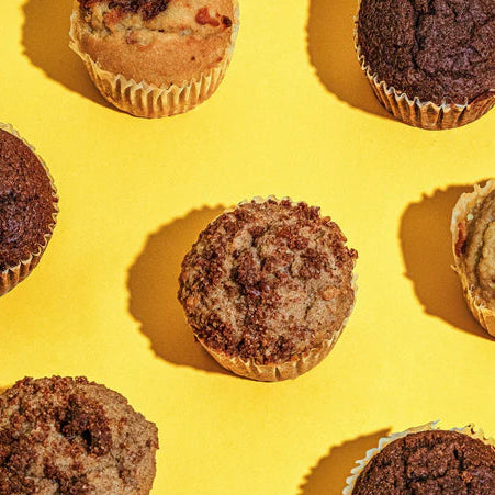 Assorted muffins on a yellow background