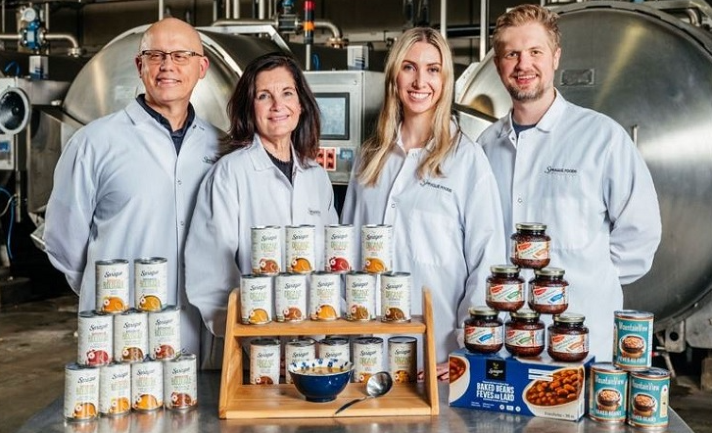 Sprague Foods team showcasing canned soups and baked beans, highlighting clean-label, mycelium-enhanced products developed in partnership with Maia Farms for sustainable, fungi-powered nutrition.